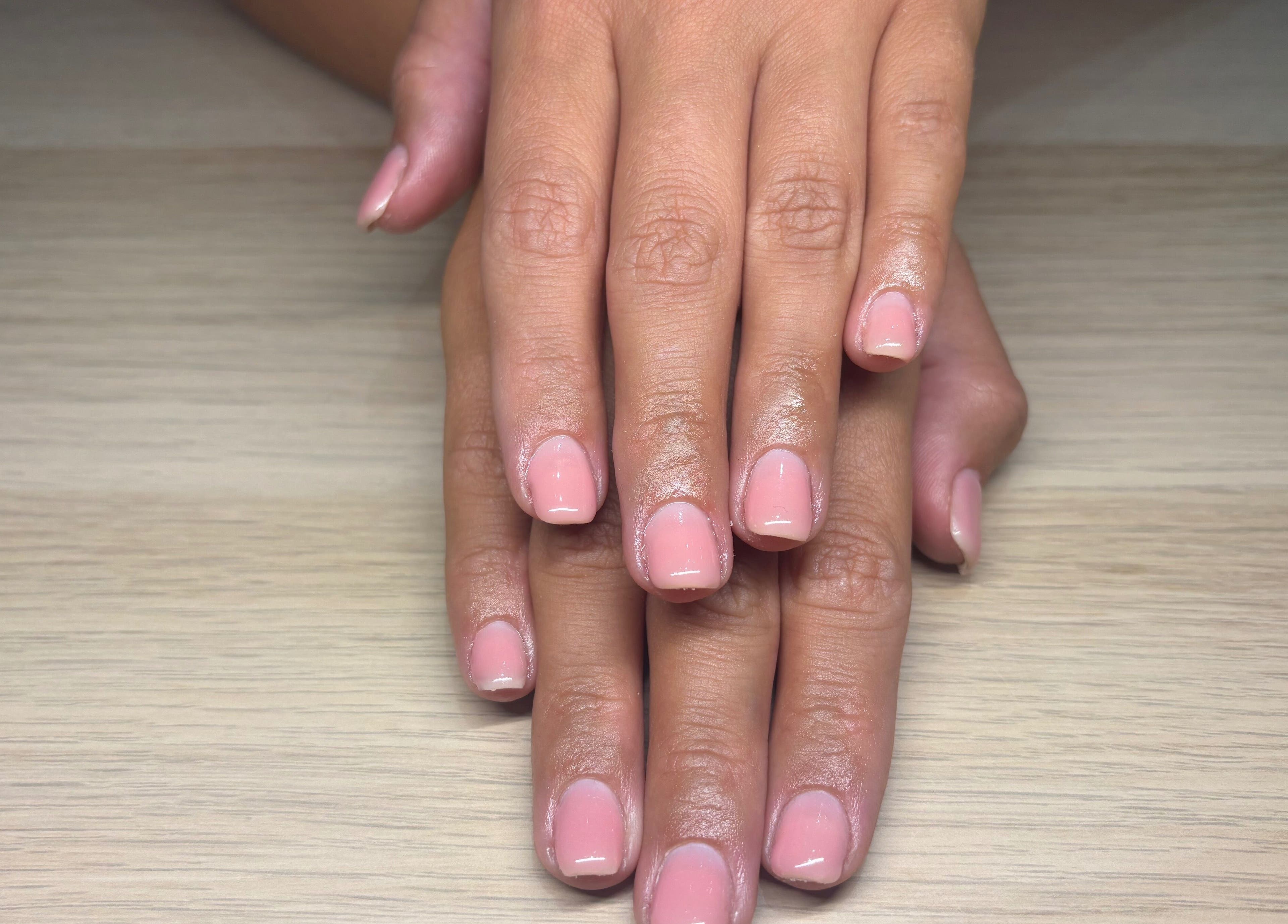 Elegant pink manicure at By Ells in Redditch, England, GB showcasing finely groomed nails.