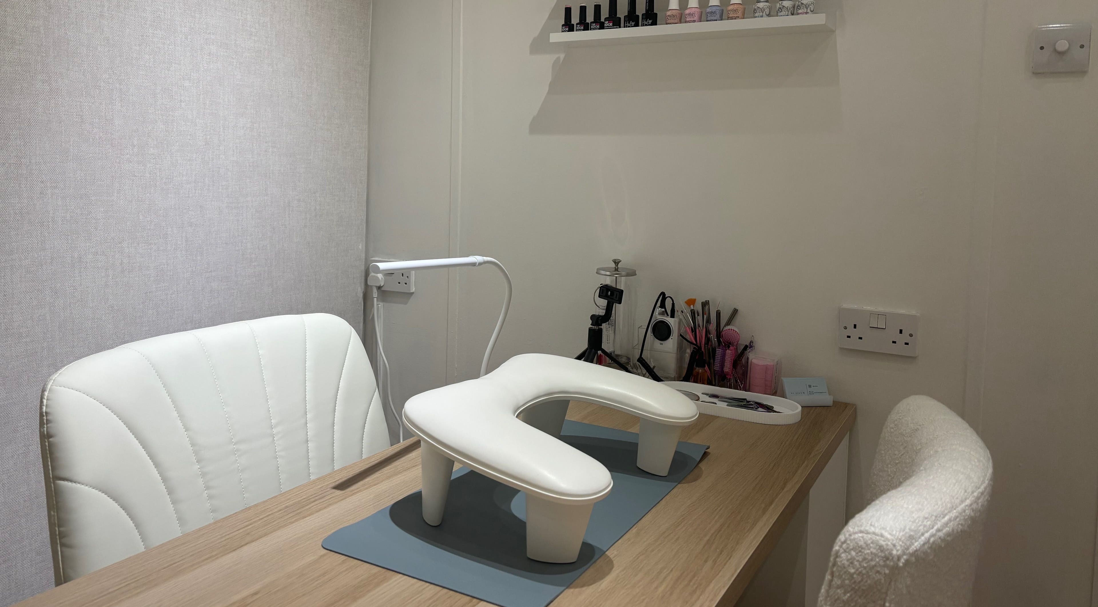 A modern nail station at By Ells, Redditch, England, GB featuring tools and a chic chair.