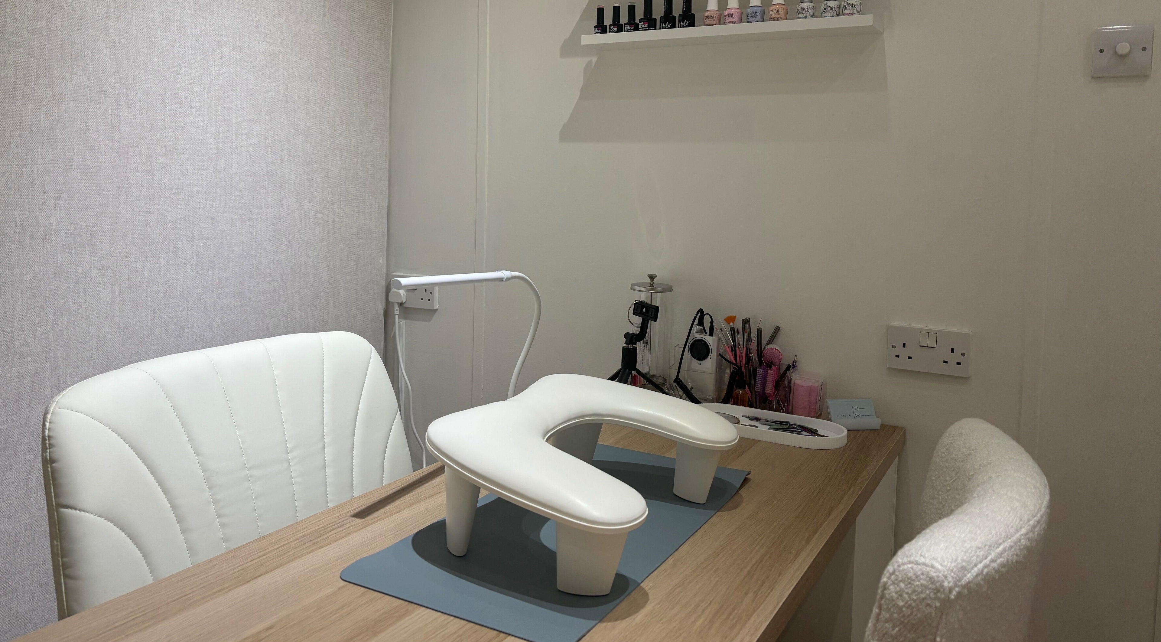 A modern nail station at By Ells, Redditch, England, GB featuring tools and a chic chair.