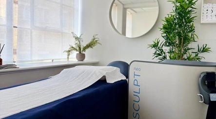 SculptMD treatment room in London, England, GB, featuring a serene setup with modern equipment and lush greenery.
