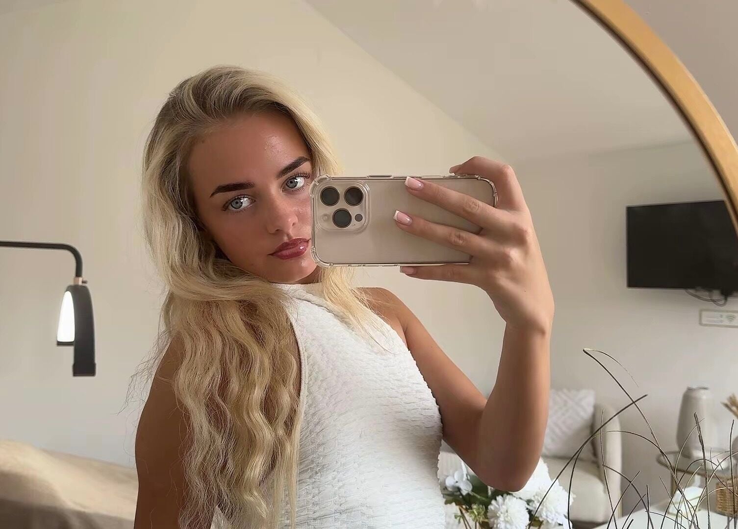 Elegant reflection of woman in Maddison Beauté Collective, Coventry, England, showcasing chic interior.