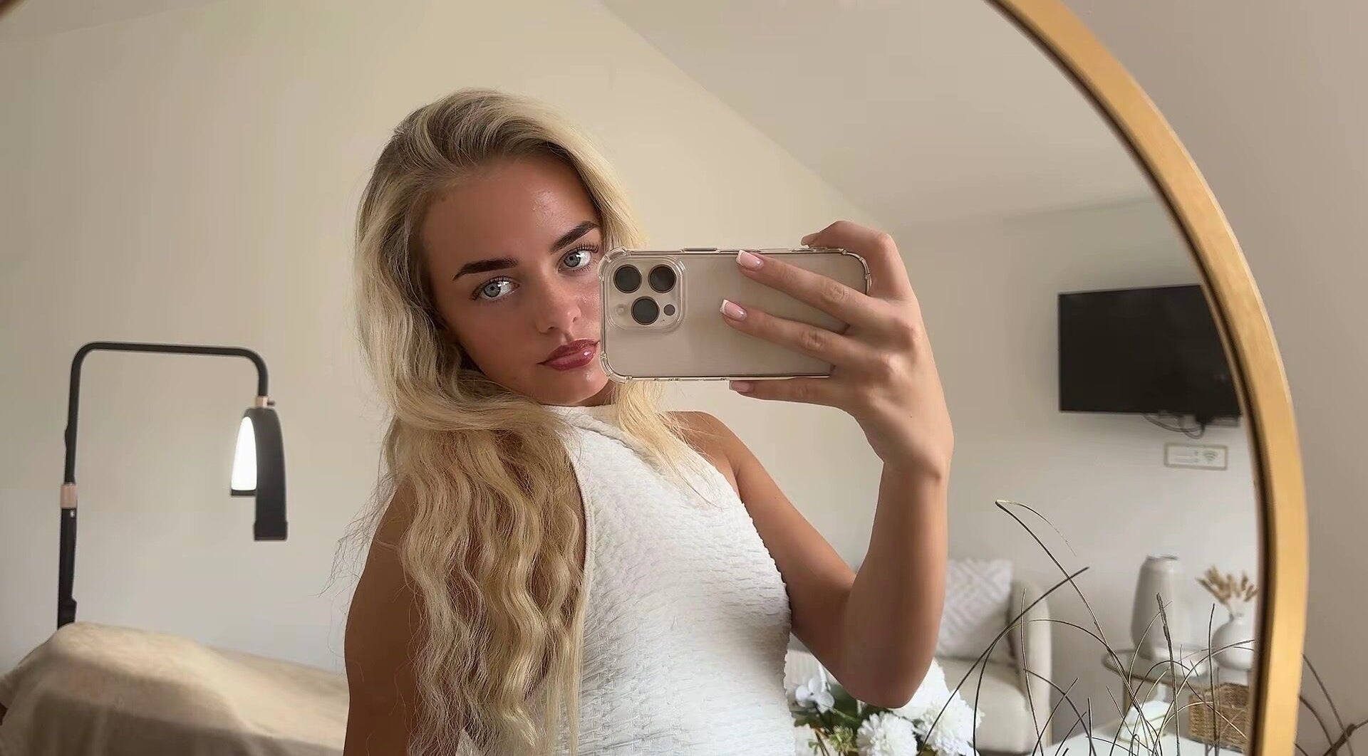 Elegant reflection of woman in Maddison Beauté Collective, Coventry, England, showcasing chic interior.