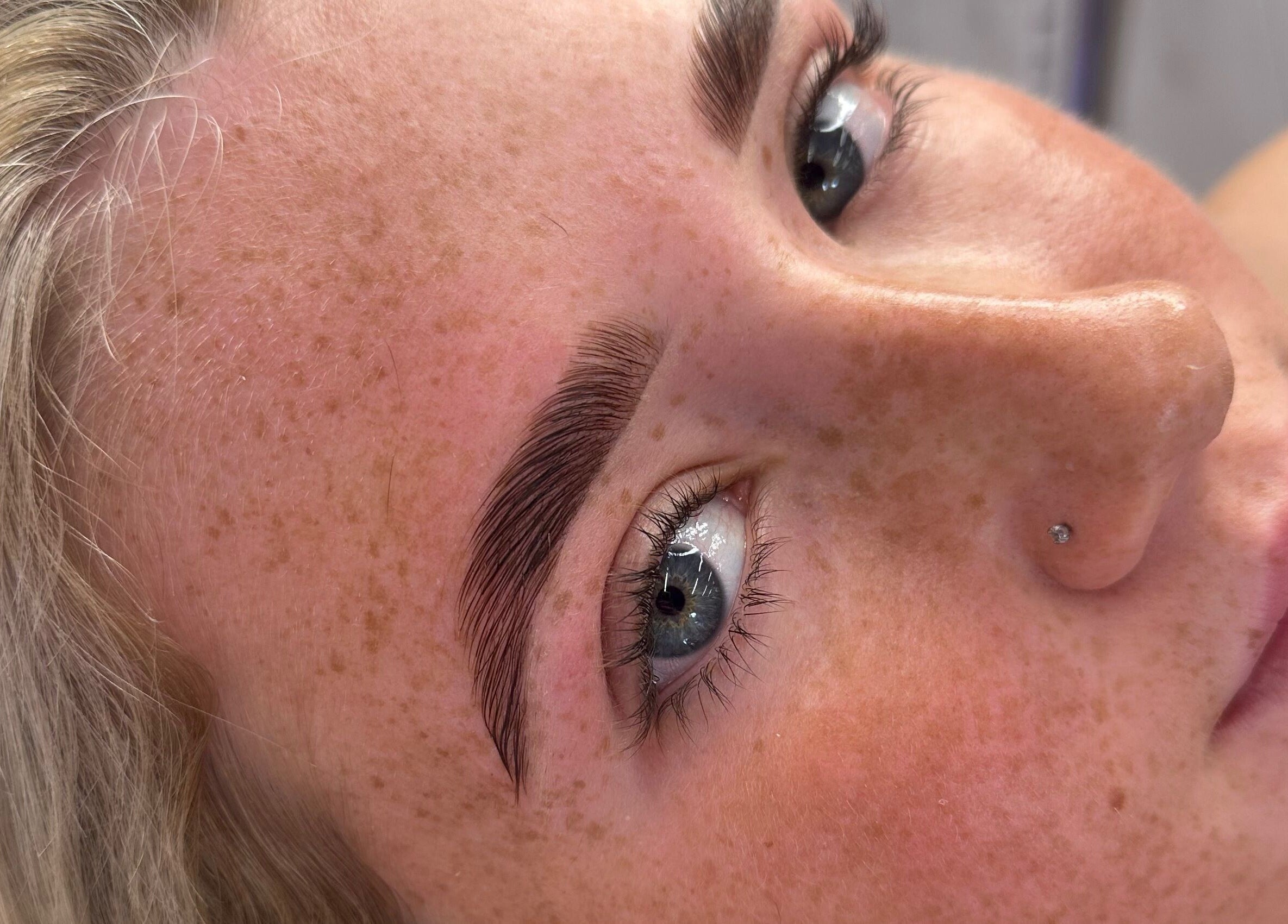 Close-up of perfectly groomed brows at Maddison Beauté Collective, Coventry, England, GB.