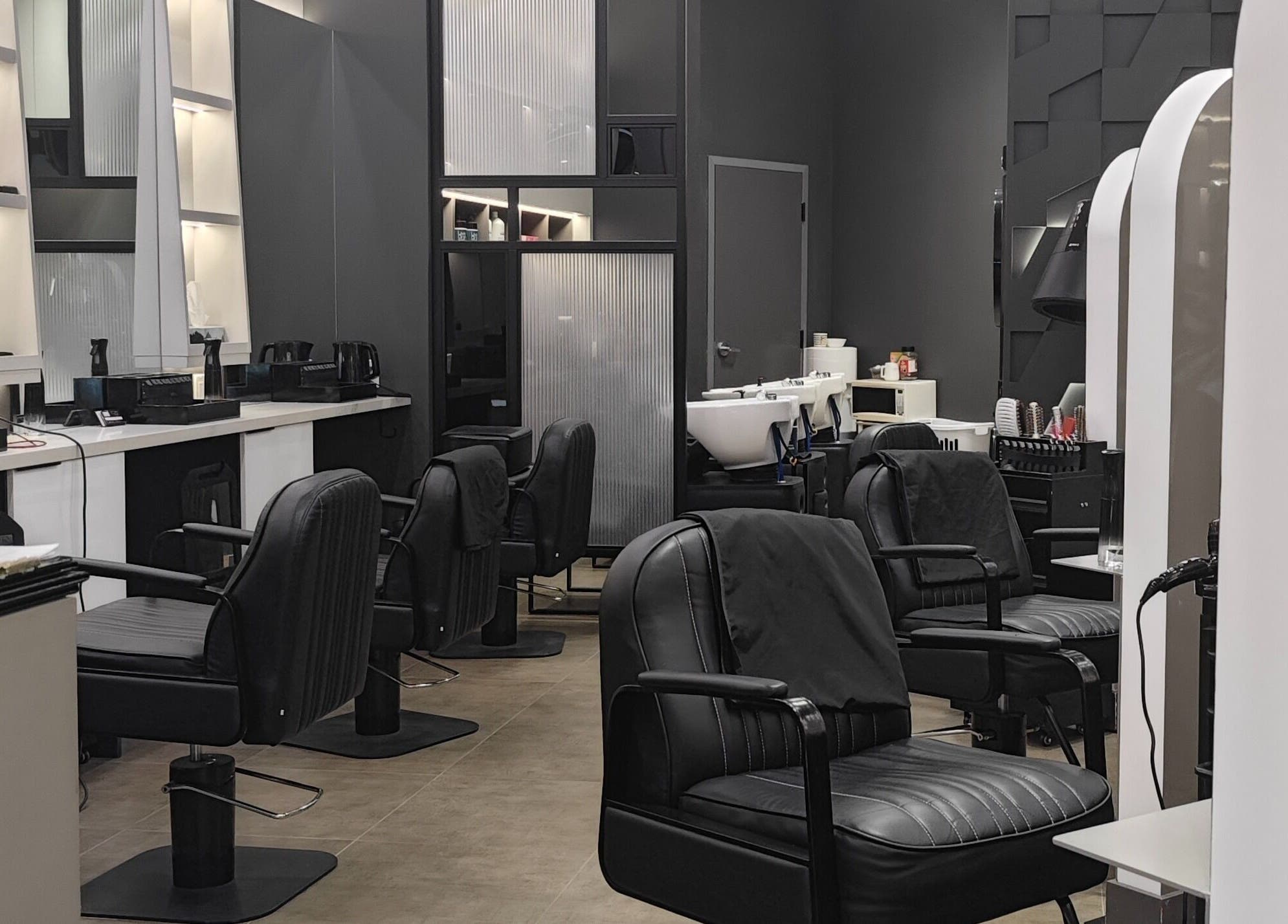 Stylish interior at Gatsby Studio Salon & Nails, Richmond Hill, Ontario, CA, featuring plush chairs and sleek decor.