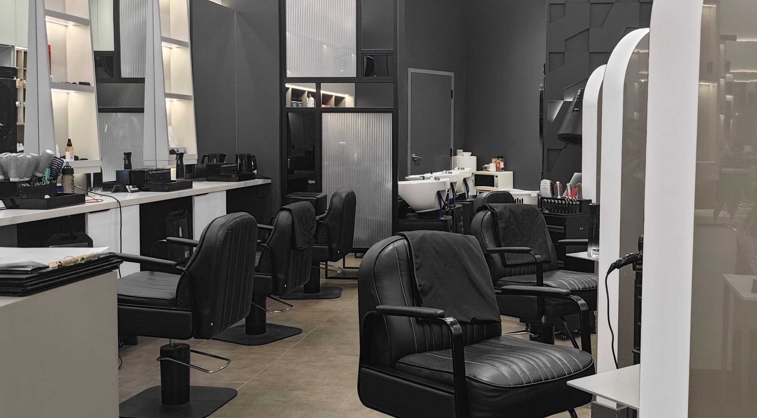 Stylish interior at Gatsby Studio Salon & Nails, Richmond Hill, Ontario, CA, featuring plush chairs and sleek decor.