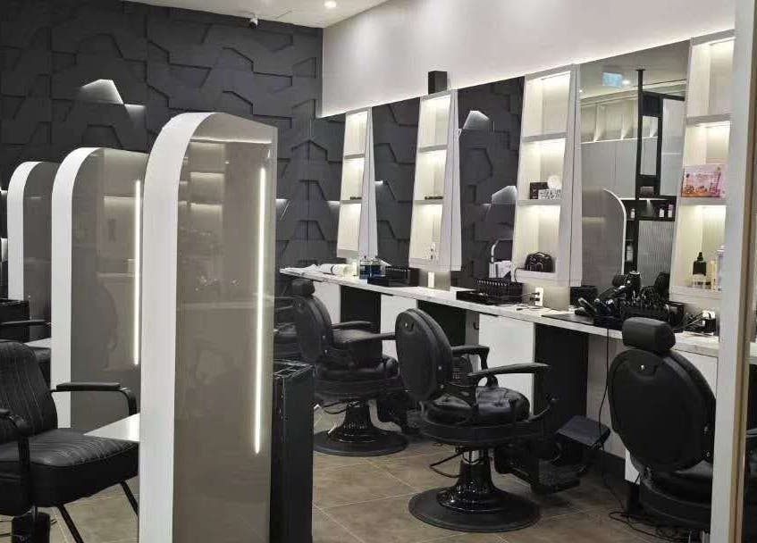 Chic and modern interior of Gatsby Studio Salon & Nails in Richmond Hill, Ontario, CA featuring sleek black chairs.