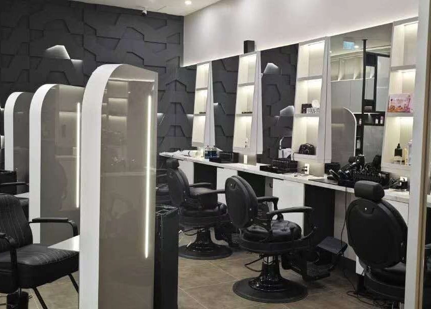 Chic and modern interior of Gatsby Studio Salon & Nails in Richmond Hill, Ontario, CA featuring sleek black chairs.
