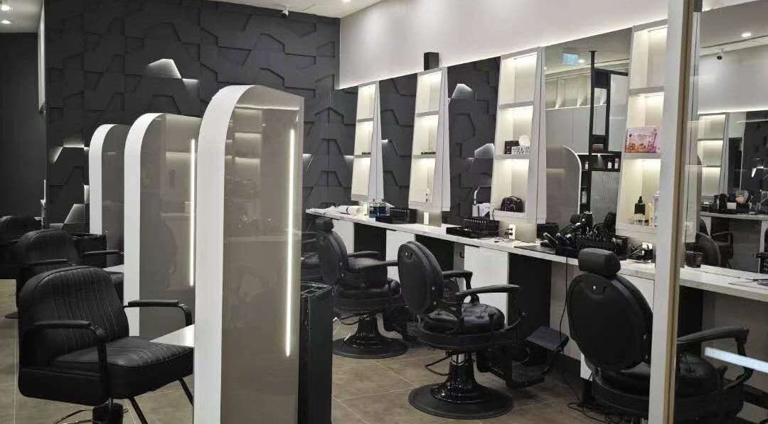 Chic and modern interior of Gatsby Studio Salon & Nails in Richmond Hill, Ontario, CA featuring sleek black chairs.