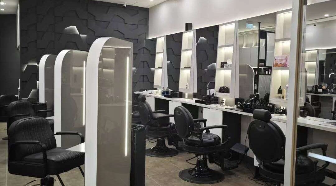Chic and modern interior of Gatsby Studio Salon & Nails in Richmond Hill, Ontario, CA featuring sleek black chairs.