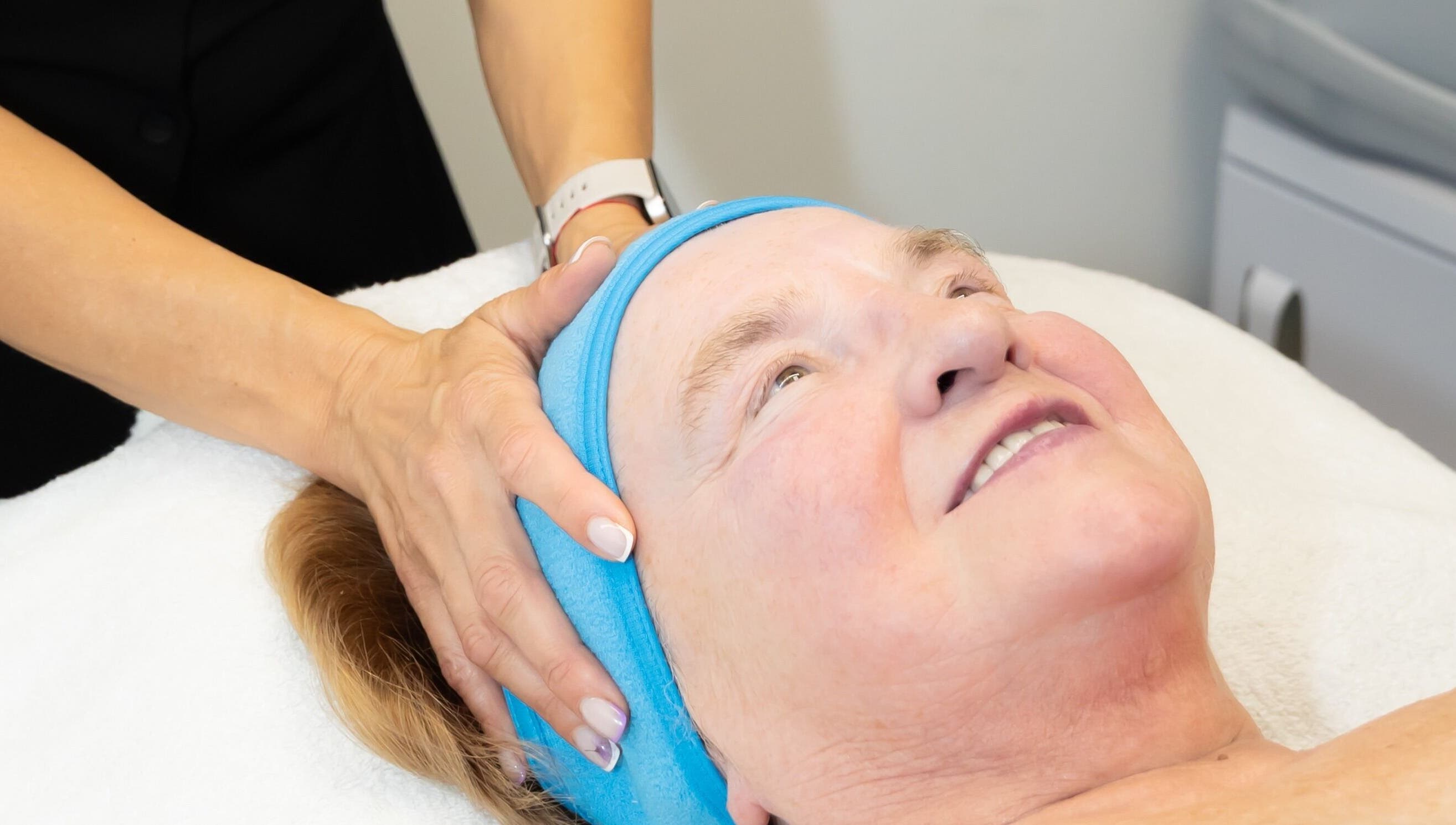 Client enjoying a facial massage at Silhouette Glow Beauty by Vaida, Armagh, Northern Ireland, GB.