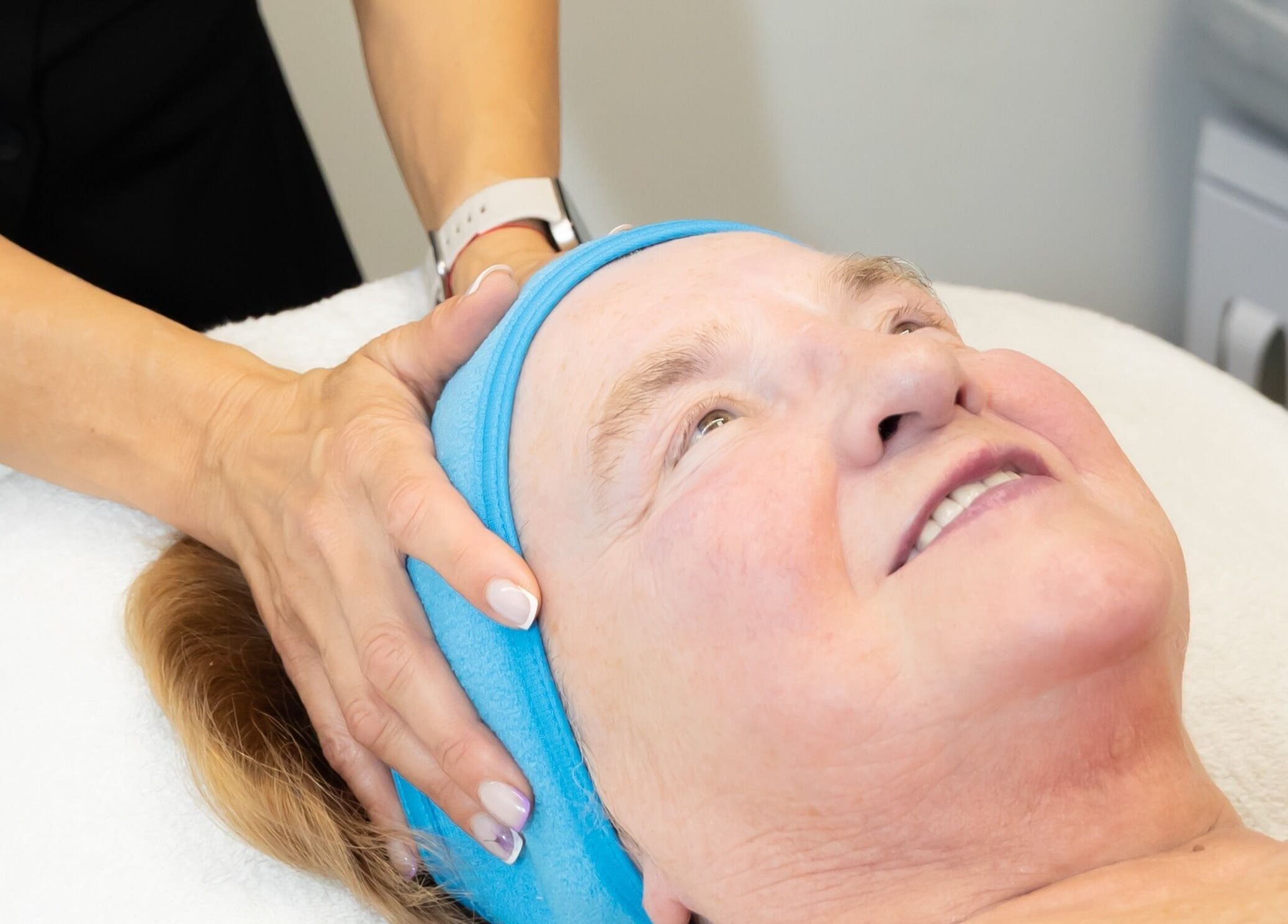 Client enjoying a facial massage at Silhouette Glow Beauty by Vaida, Armagh, Northern Ireland, GB.