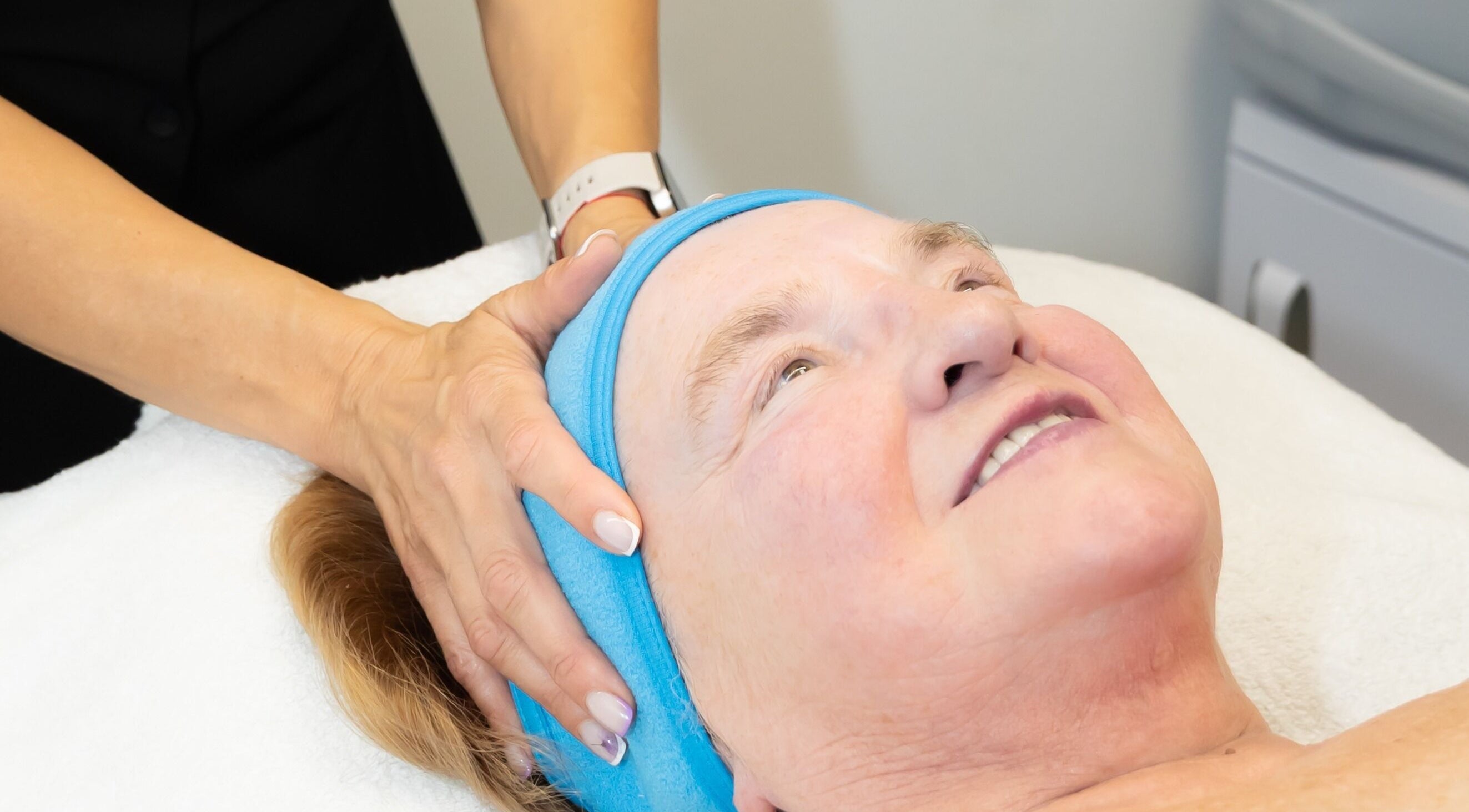 Client enjoying a facial massage at Silhouette Glow Beauty by Vaida, Armagh, Northern Ireland, GB.