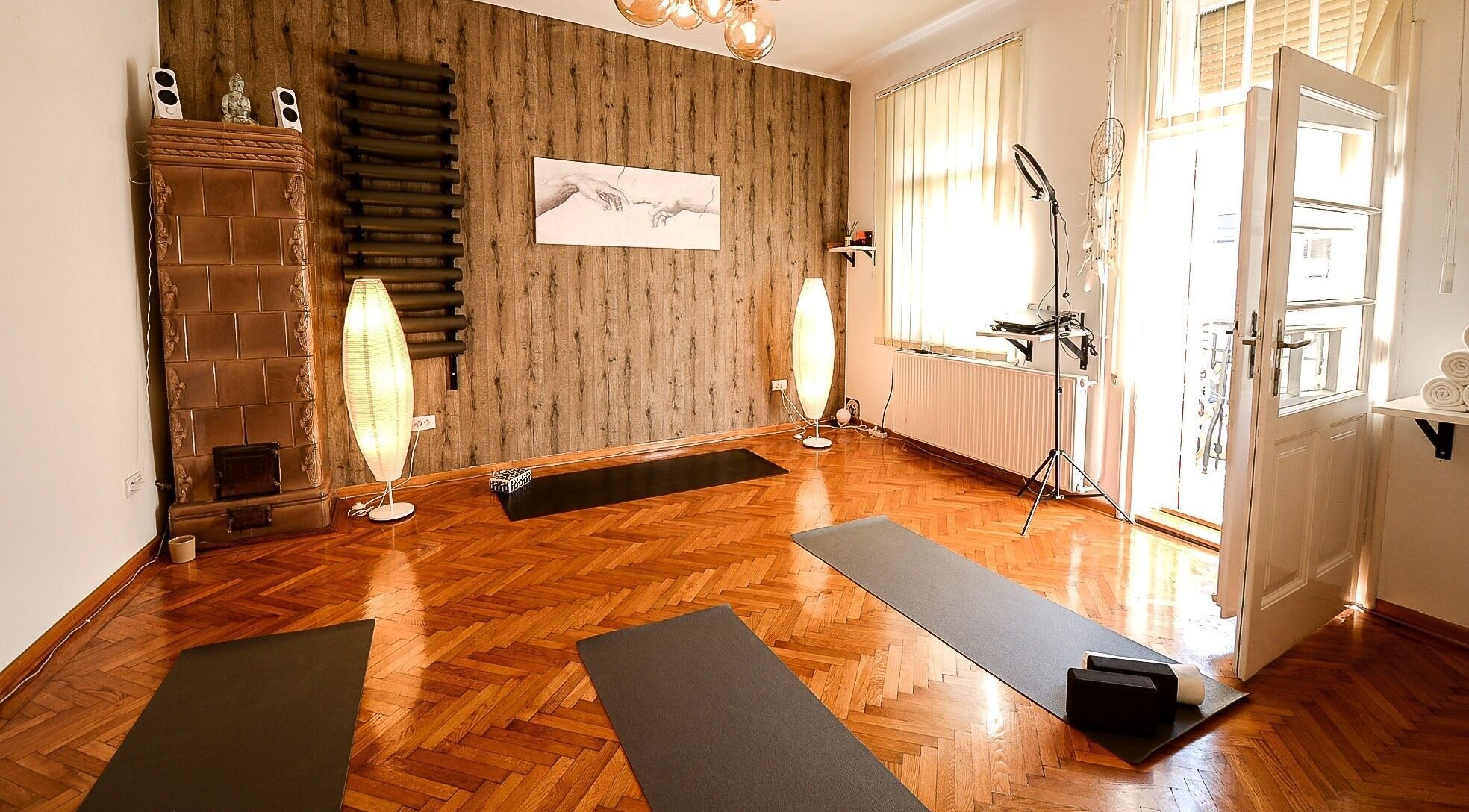 Yoga studio at Moon Energy, Beograd, RS, featuring tranquil decor and yoga mats on wooden flooring.