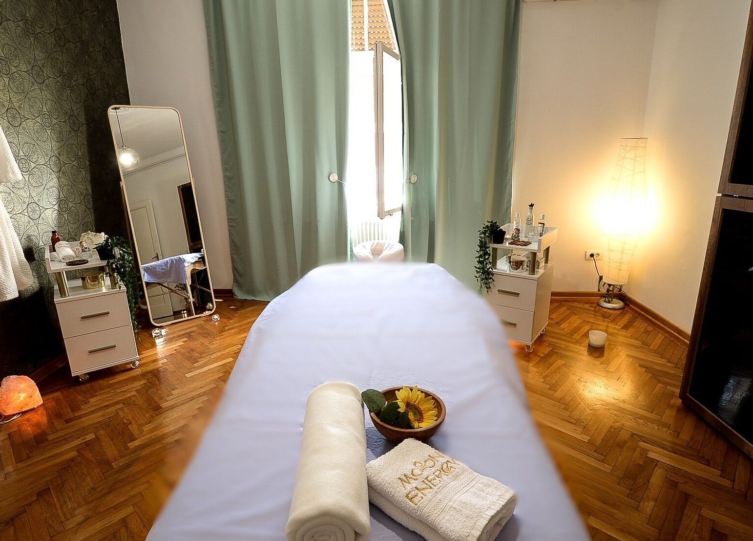 Relaxing spa room at Moon Energy in Beograd, RS, featuring a massage table and soft lighting.
