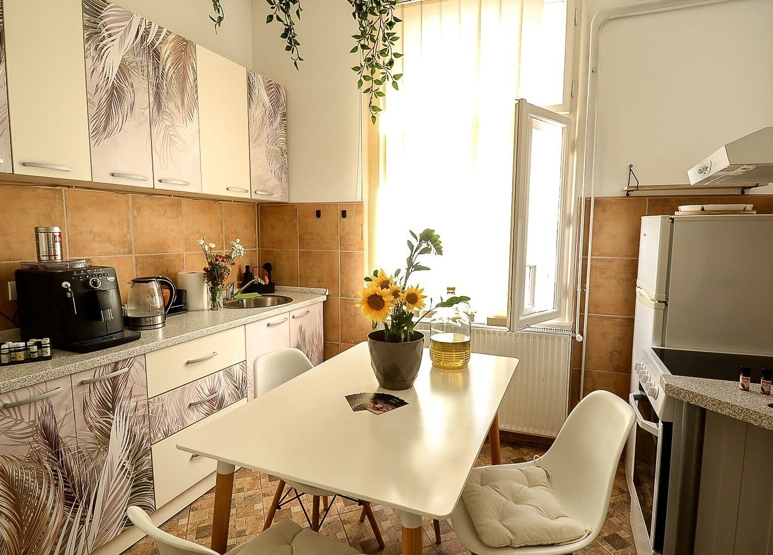 Bright kitchen at Moon Energy, Beograd, RS featuring elegant decor and lush greenery.