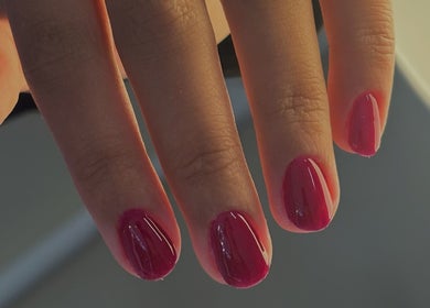 Perfect manicure with red nails at Pamira Nails, London, England, GB, showcasing sleek and glossy finish.
