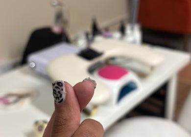 Close-up of stylish leopard nail art at Pamira Nails, London, England, GB.