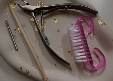 Nail care tools including clippers and brush at Pamira Nails, London, England, GB.