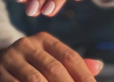 Close-up of manicured hands at Pamira Nails, London, England, GB, showcasing elegant glossy finish.