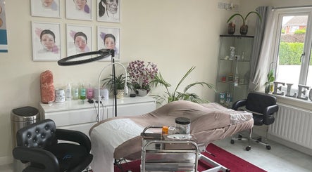 Relaxing treatment room at Elegance Beauty & Aesthetics, March, England, GB, featuring a plush bed and stylish decor.