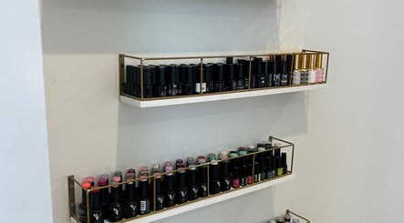 Nail polish shelves at 11:11 Nails By Jordan in Dalton Gardens, Idaho, US showcasing diverse colors.