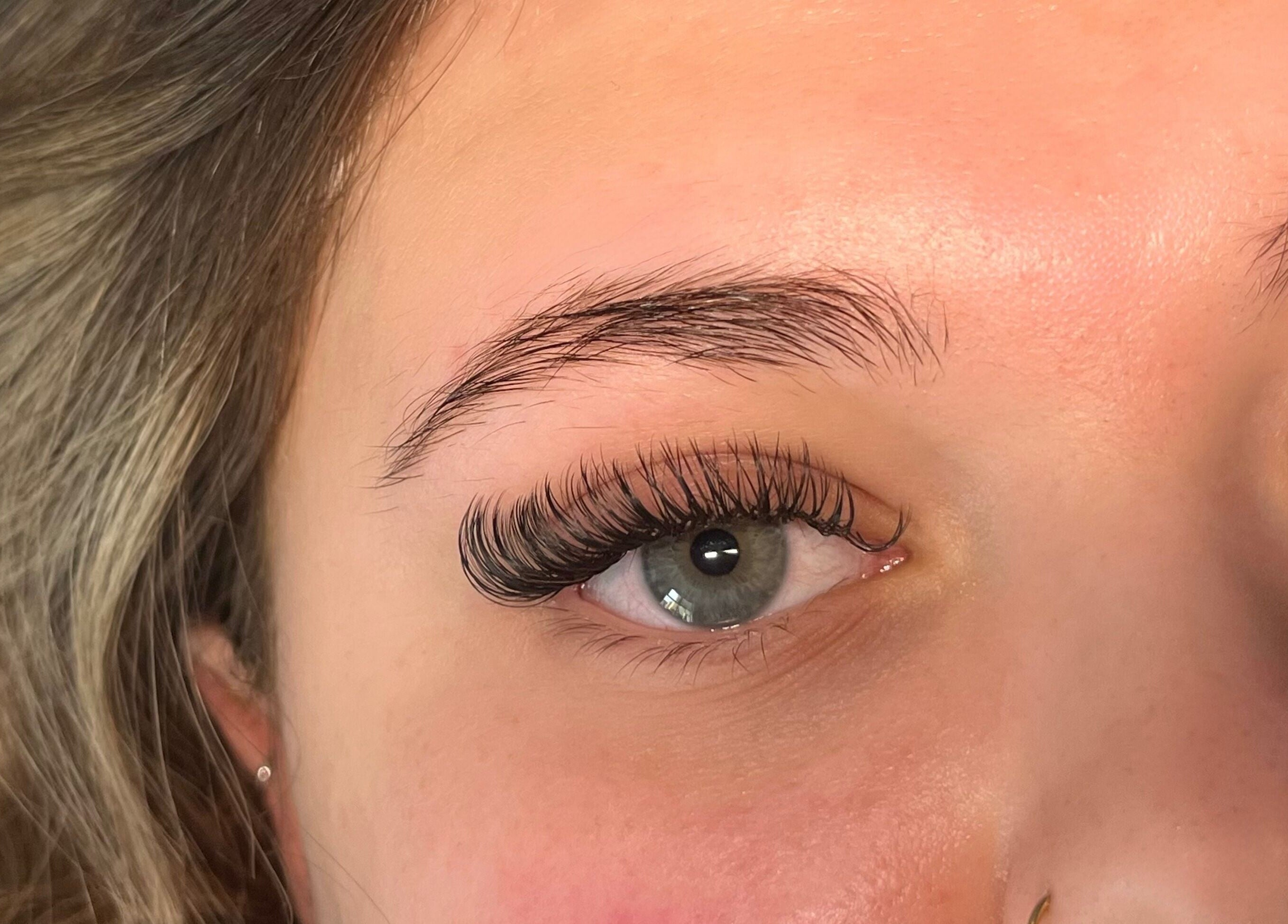 Close-up of eyelash extensions by Lashes by Lydia in Pickering, England, GB, enhancing blue eyes.