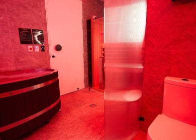 Relaxing sauna with warm red lighting at Vita Health Club, North Willoughby, New South Wales, AU.