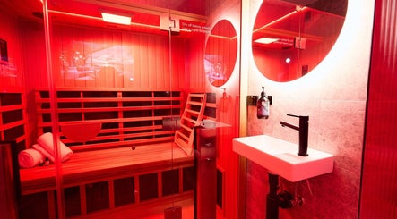 Relaxing sauna room at Vita Health Club, North Willoughby, New South Wales, AU with red ambient lighting.