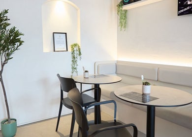 Elegant seating area at Vita Health Club, North Willoughby, New South Wales, AU featuring sleek tables and chairs.