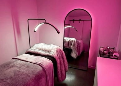 Relaxing pink-hued treatment room at LASHOGRAPHER, Leicester, England, GB for a serene beauty experience.