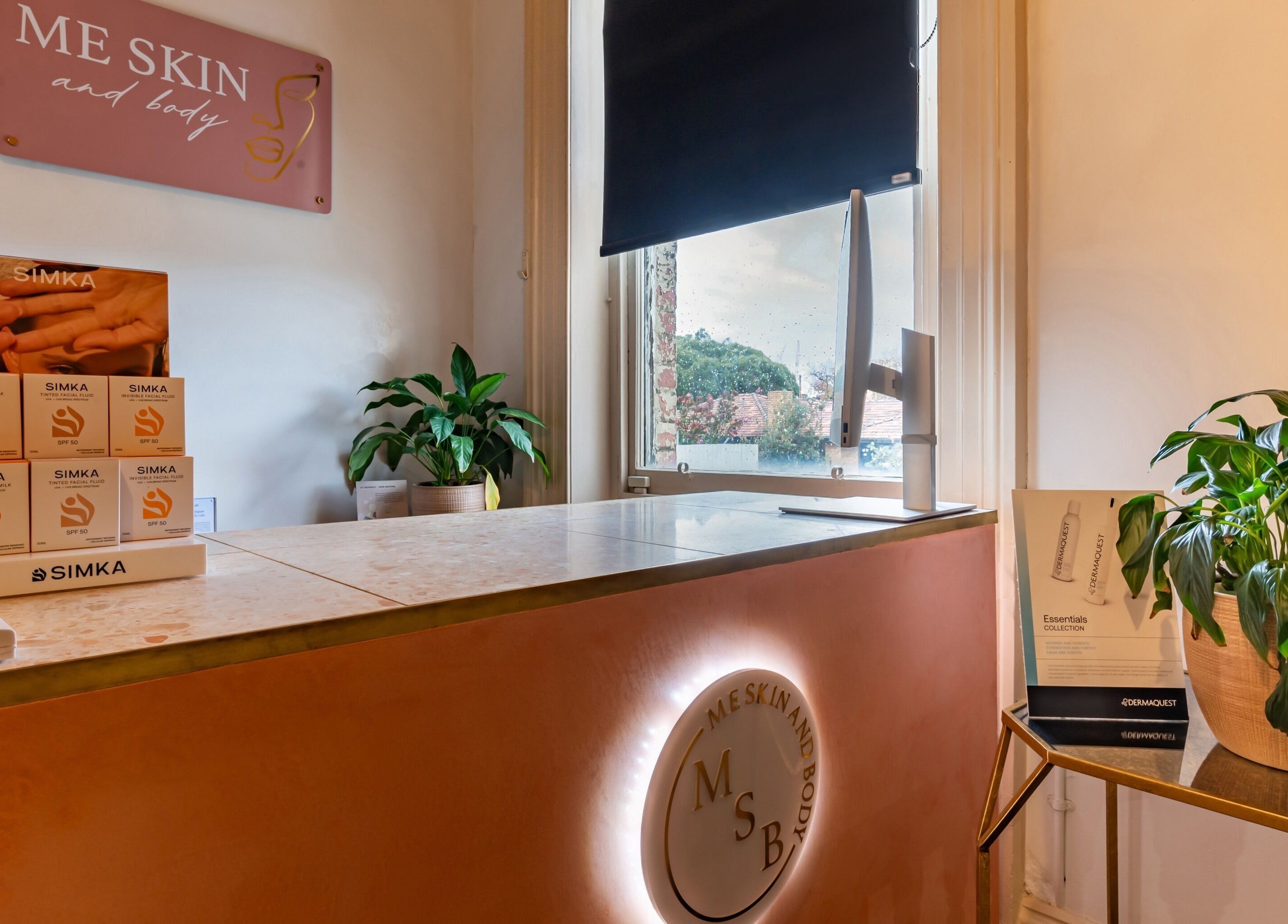 Reception desk at Me Skin and Body, Melbourne, Victoria, AU. Showcases products and greenery.