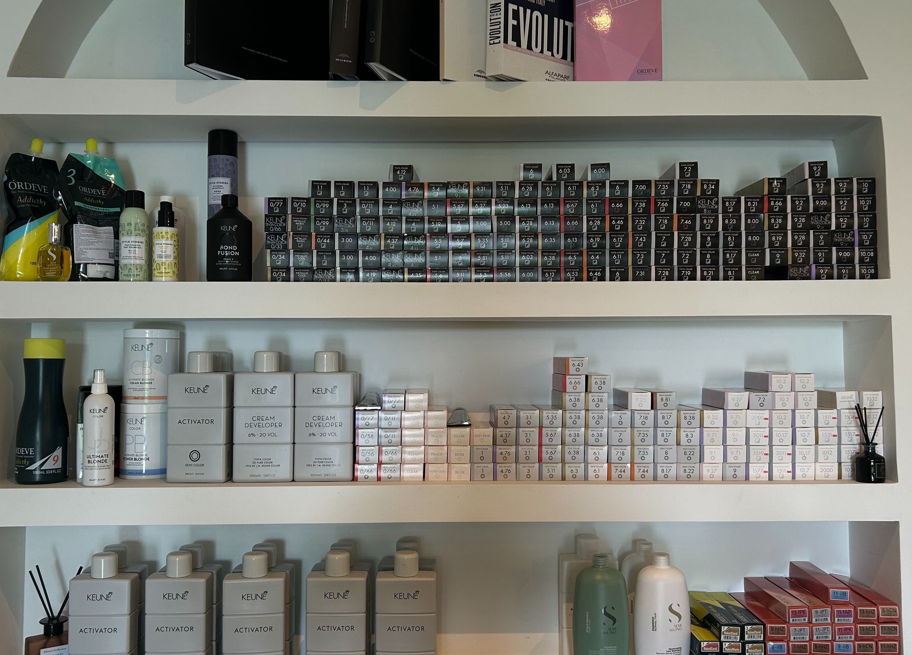 Well-organized beauty product shelf at Shaz Salon Beauty Wellness, Bali, Bali, ID, showcasing various hair care items.