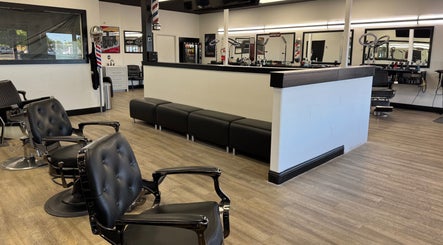 Modern salon interior at Ruben Carreon in Yuba City, California, US featuring stylish black chairs and mirrors.