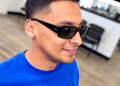 Man in sunglasses at Ruben Carreon, Yuba City, California, US, enjoys fresh style.