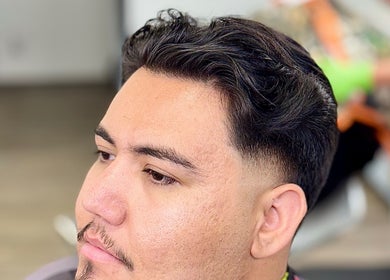 Modern male haircut at Ruben Carreon in Yuba City, California, US, showcasing precision styling.