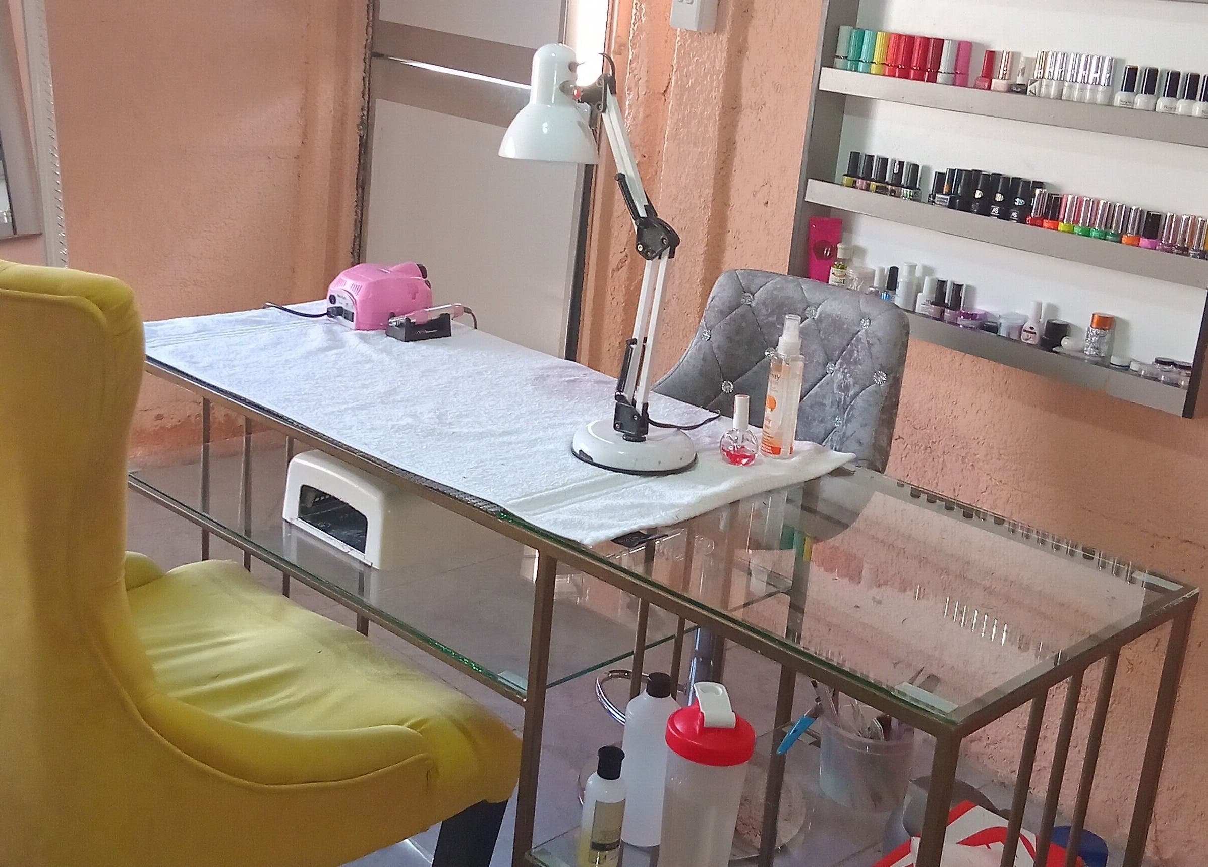 Nail station at Imbewuenhle Beautology in Benoni, Gauteng, ZA. Features manicure tools and vibrant polishes.
