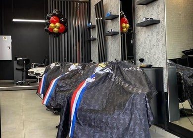 Modern interior of Young Barber Mulbarton in Johannesburg, Gauteng, ZA with sleek chairs and mirrors.