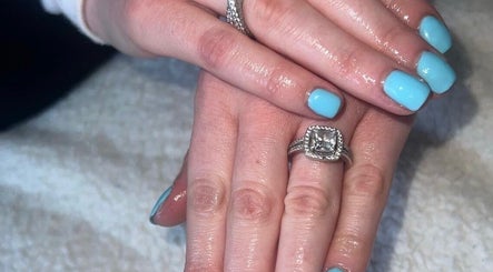 Gleaming blue nails with rings at RDHNails, Birmingham, England, GB showcasing modern manicure artistry.