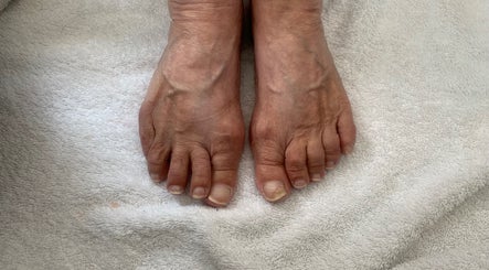 Close-up of feet on soft towel at RDHNails, Birmingham, England, GB, highlighting natural pedicure services.