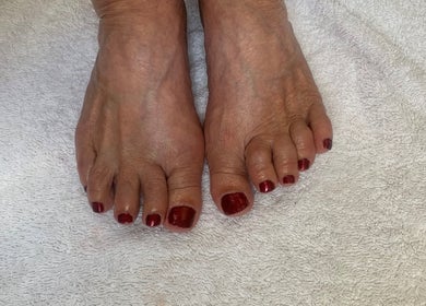 Elegant pedicure with red polish at RDHNails, Birmingham, England, GB, showcasing professional nail care.