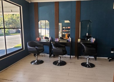 Chic salon interior at Indie Hair, Windsor, Queensland, AU with stylish chairs and mirrors.