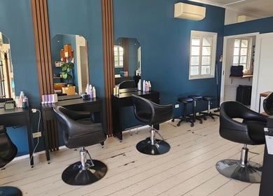 Sleek styling area at Indie Hair, Windsor, Queensland, AU with modern chairs and mirrors.