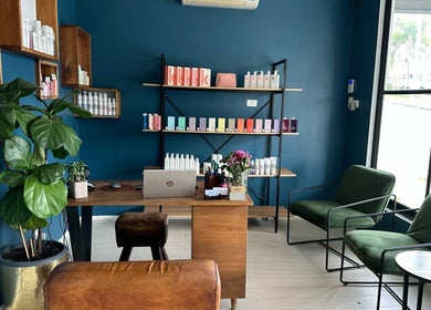 Indie Hair reception area with stylish decor in Windsor, Queensland, AU, showcasing product shelves.
