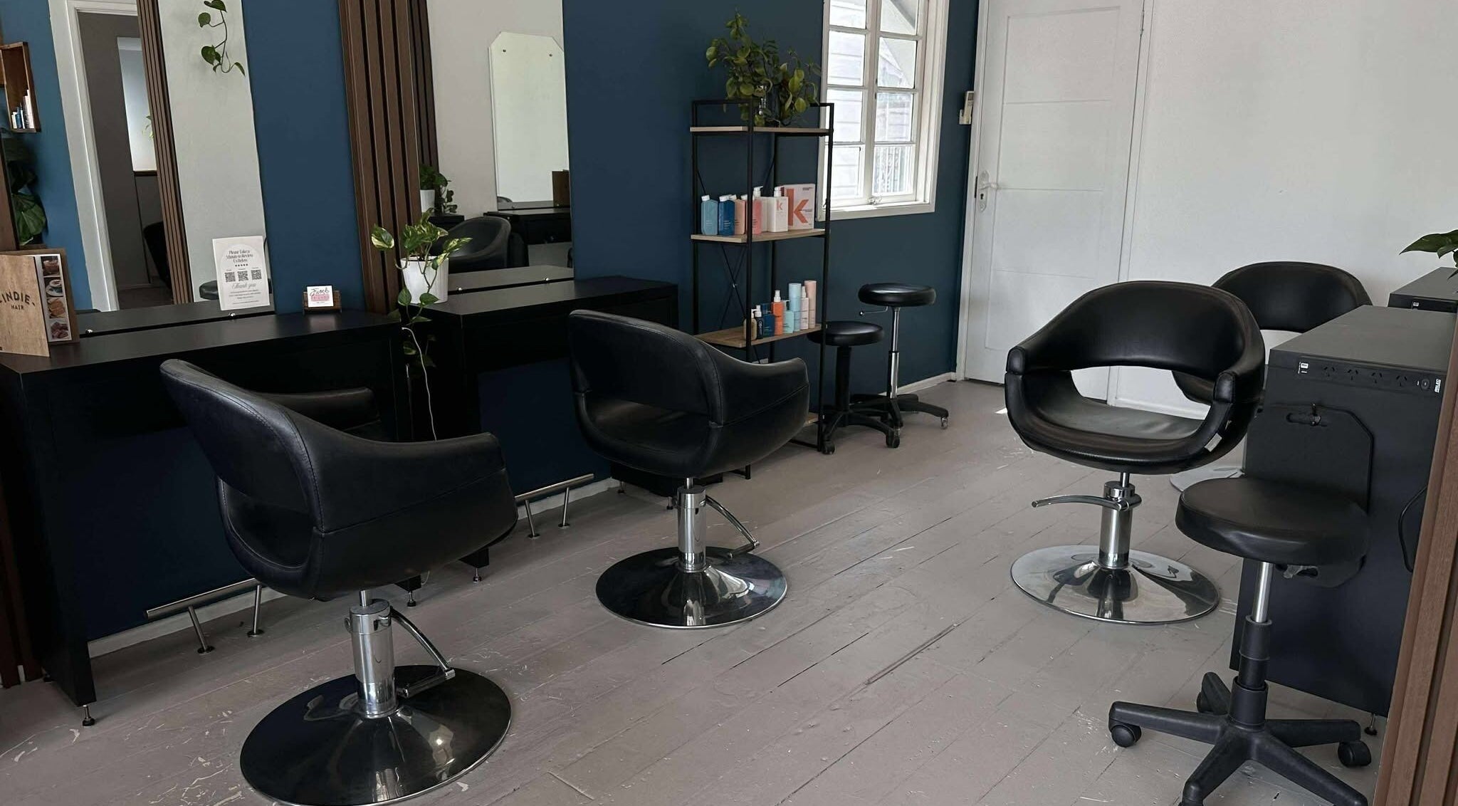 Modern salon chairs and mirrors at Indie Hair, Windsor, Queensland, AU for a stylish makeover experience.