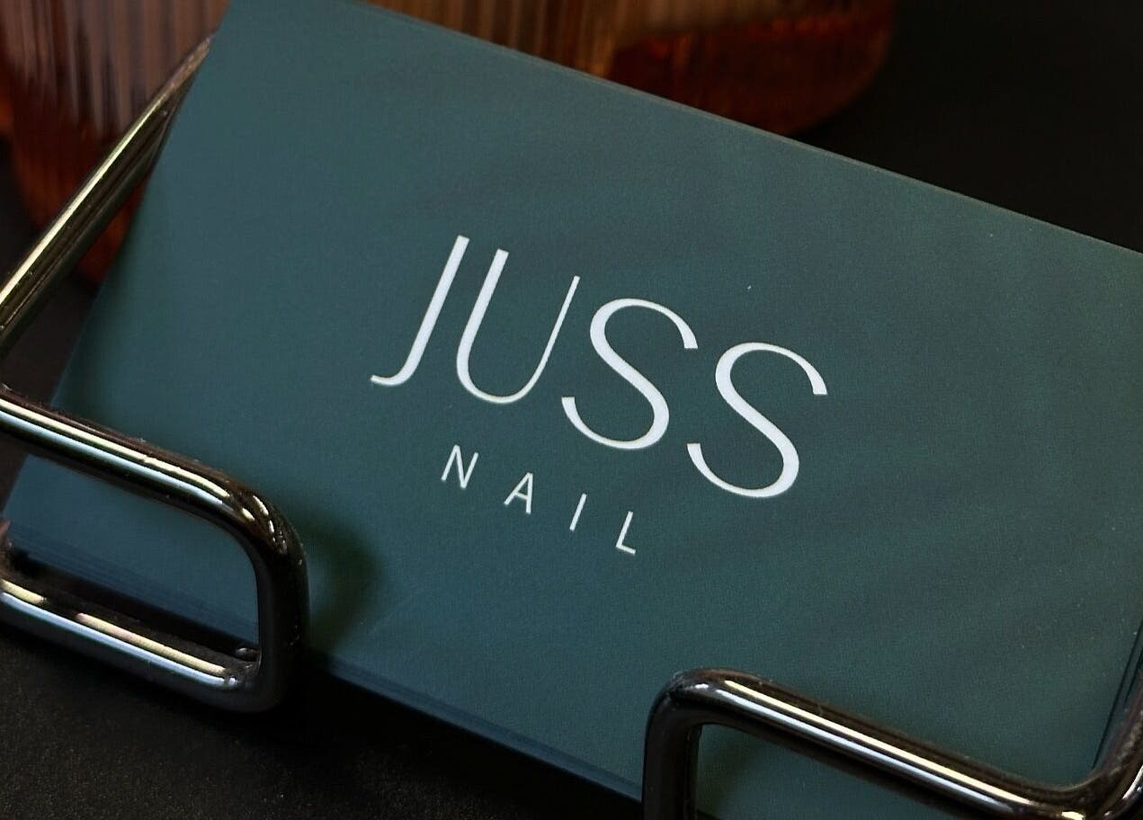 Juss.nail business cards on holder at Amsterdam, Noord-Holland, NL. Elegant display for a beauty venue.