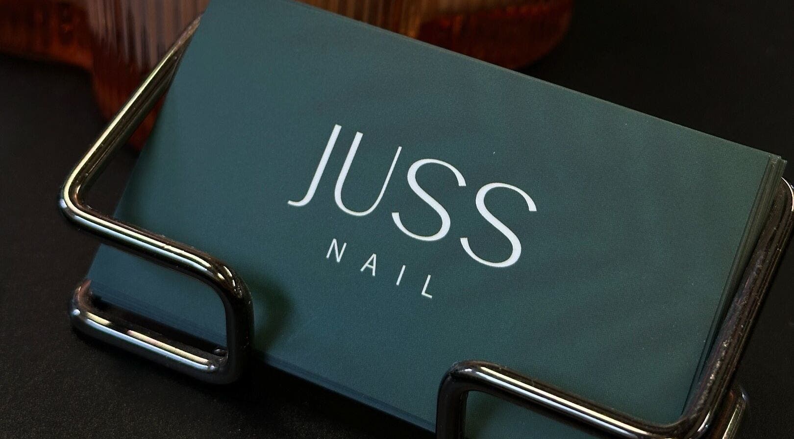 Juss.nail business cards on holder at Amsterdam, Noord-Holland, NL. Elegant display for a beauty venue.