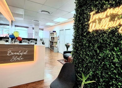 Reception area at Innermost Wellbeing in Cape Town, Western Cape, ZA, featuring lush greenery and seating.