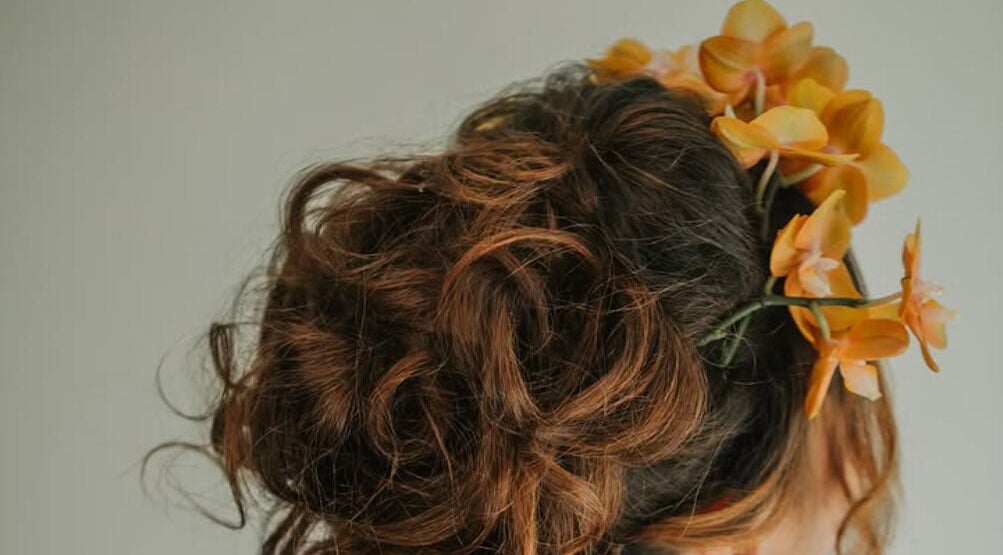 Elegant updo with orange orchids at Shiroy, Cape Town, Western Cape, ZA.