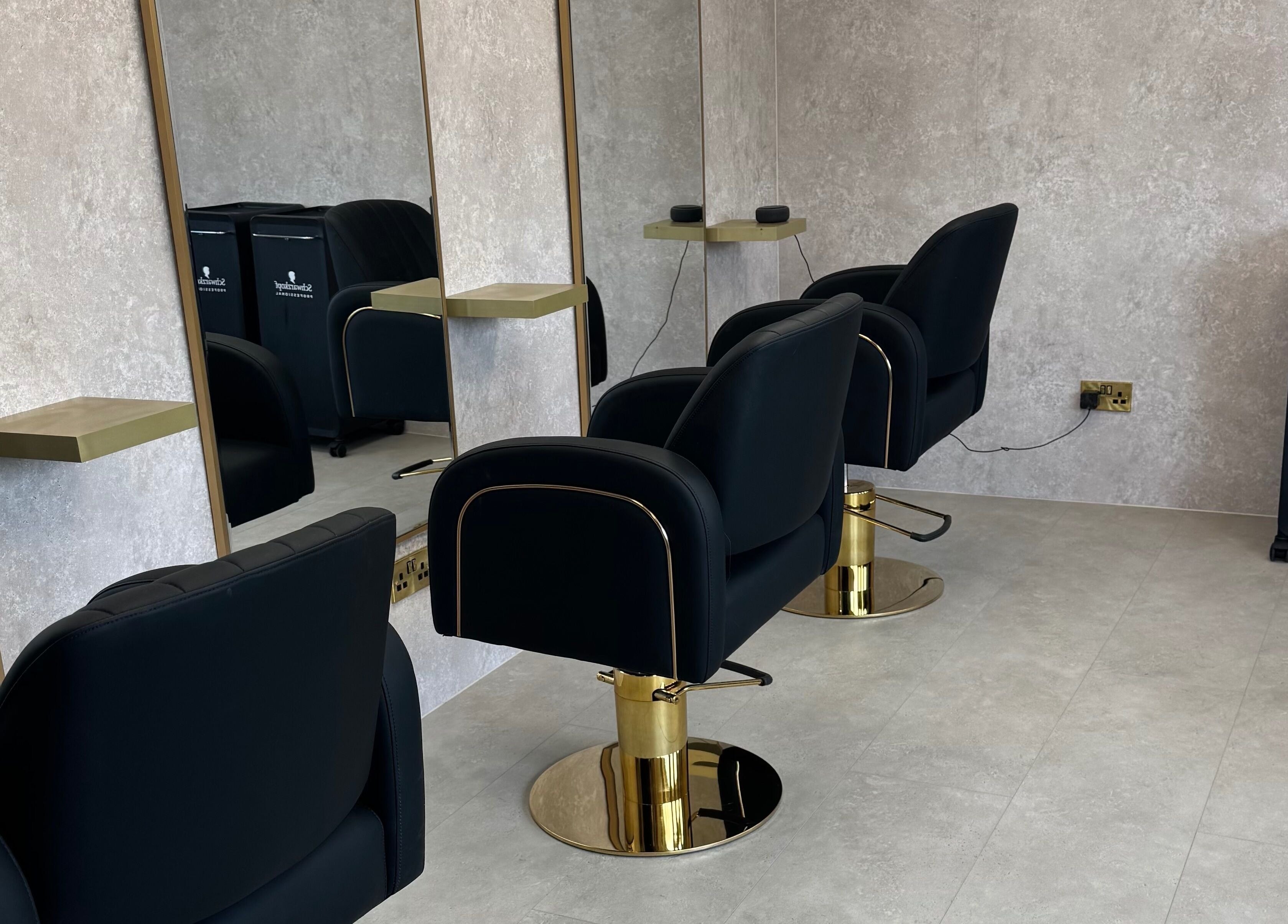 Sleek salon setup at The Hair Edit by caitlin- at Solea Salon in Motherwell, Scotland, GB with modern black chairs.
