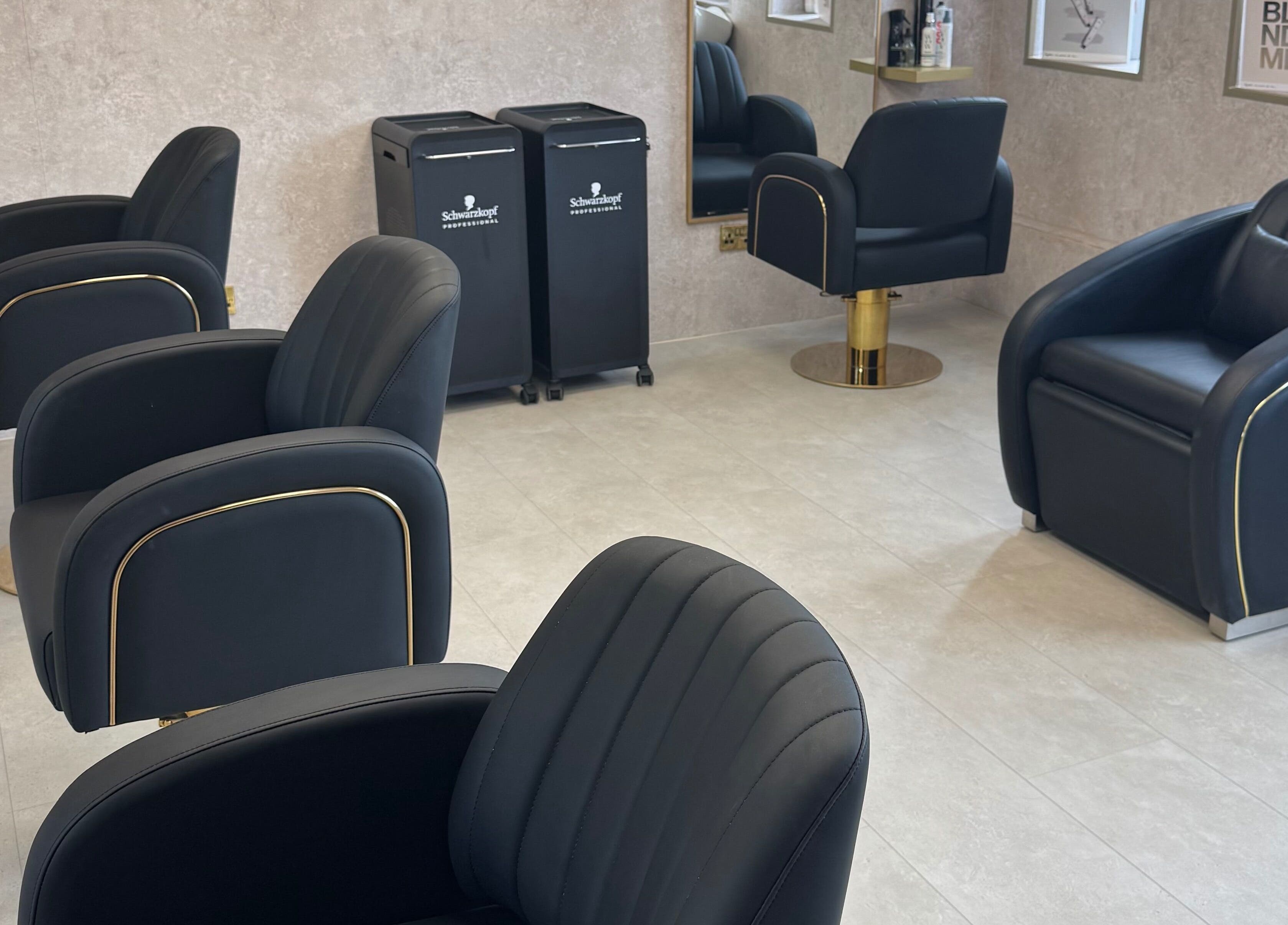 Stylish seating at The Hair Edit by caitlin- at Solea Salon, Motherwell, Scotland, GB, featuring modern black chairs.